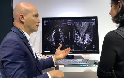 AI is still one of the key technologies on the floor that many radiologists want to learn more about. A product rep discussing breast automated detection AI in the crowded Lunit booth at RSNA 2022.