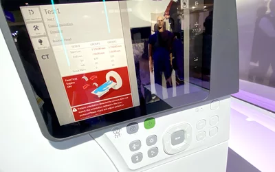 AI-enabled patient isocentering system showing an alert that the patient needs to face a different direction for the imaging protocol being scanned on the GE Omni Legend PET/CT nuclear imaging system at RSNA 2023. These types of AI alerts for the technologist can save time and prevent rescanning or recalling patients for another scan due to poor diagnostic image quality. This AI was cleared by the FDA in January 2020. Photo by Dave Fornell