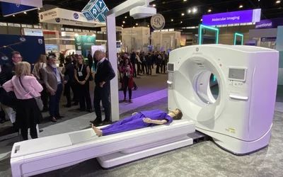 The overhead AI-enabled patient isocentering gantry of the GE Revolution Apex CT system at RSNA 2023. The overhead camera detects the patient and the table and can automtaically determine if a patient needs to be repositioned, or can recenter the table to enable optimal scan image quality. Photo by Dave Fornell