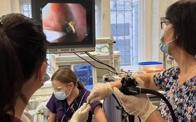 Physicians extracting a 19 cm toothbrush from the esophagus of a teenager who swallowed it by accident when trying to cause vomiting after eating in an attempt to loose weight. The hospital said they remove a few tooth brushes each year for this reason. Photos courtesy of Okhmatdyt Children's Hospital, Kyiv, Ukraine.