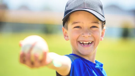 Kid holding baseball