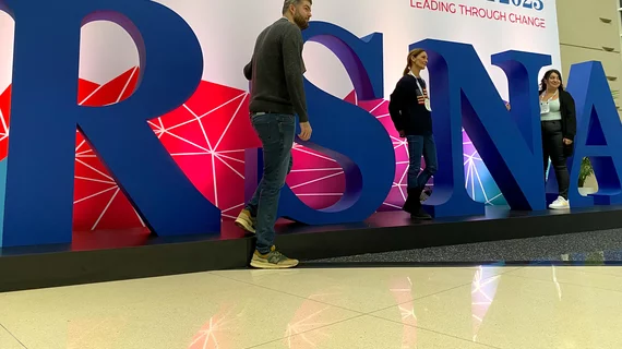 Attendees getting photos with the large logo at RSNA 2023. Photo by Dave Fornell
